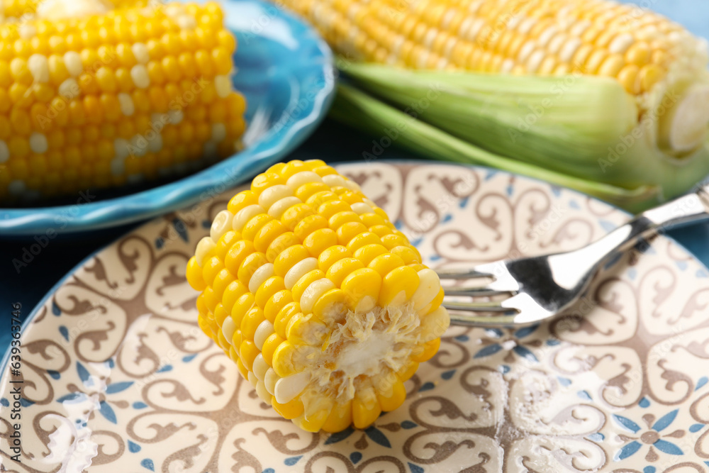 Plate of boiled corn cob on table, closeup