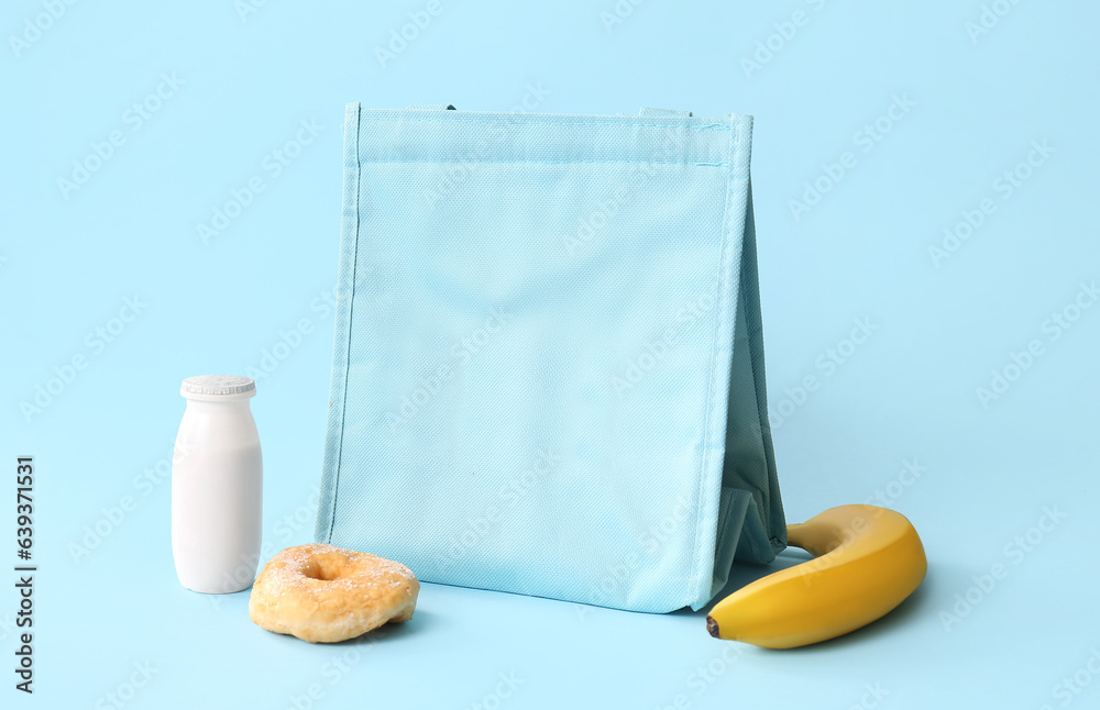 Lunch box bag with tasty food and drink on blue background