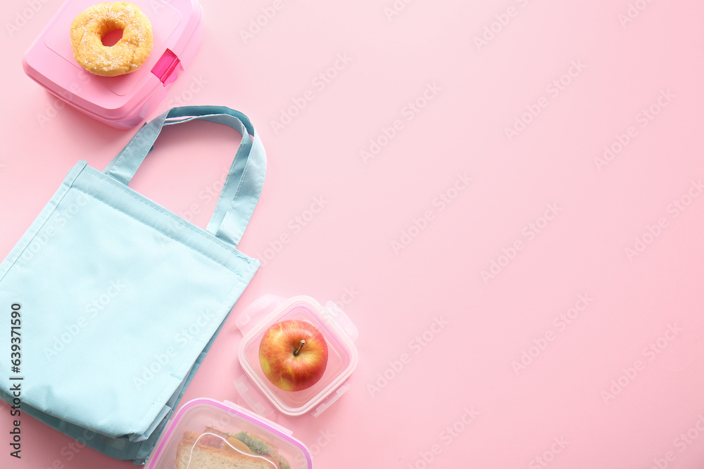 Bag and lunchboxes with delicious food on pink background