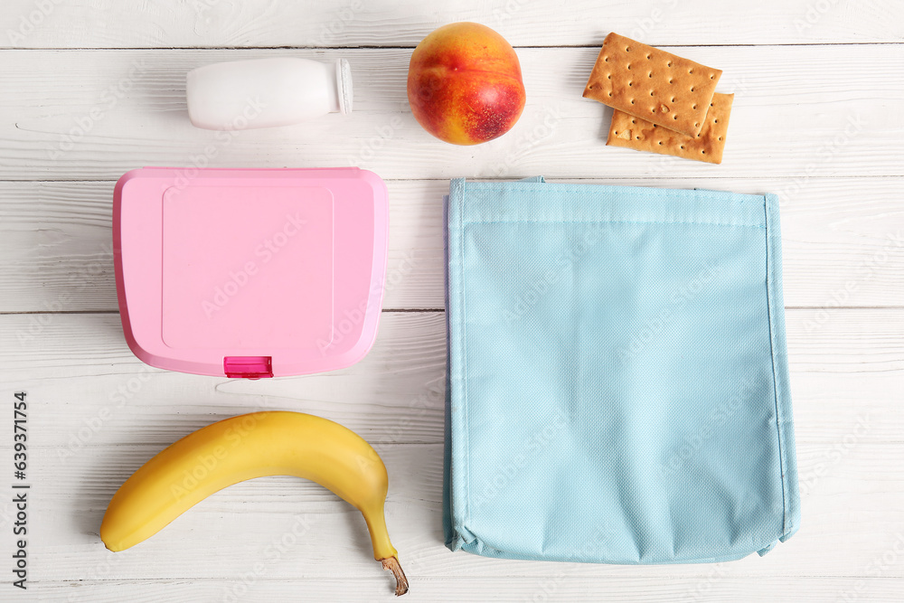 Bag, lunchbox with delicious food and drink on white wooden background