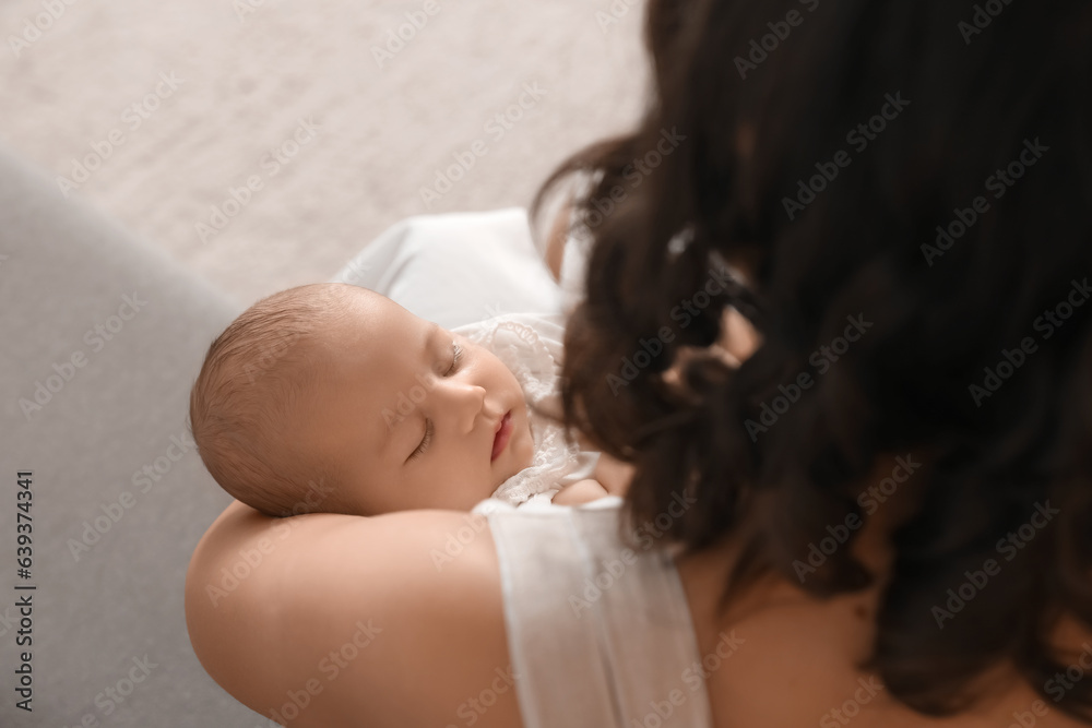 Young woman with her baby at home, closeup