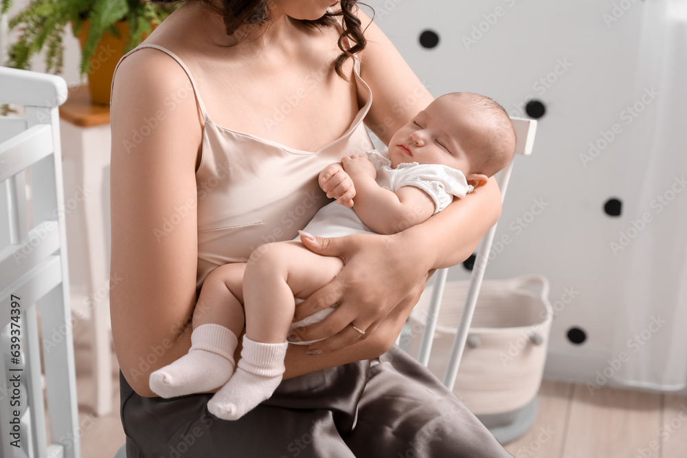 Young woman with her sleeping baby in bedroom, closeup