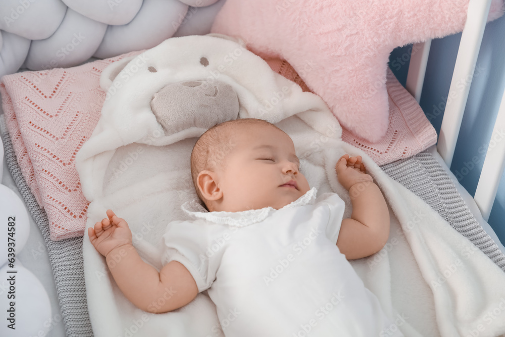 Cute baby lying in crib, closeup