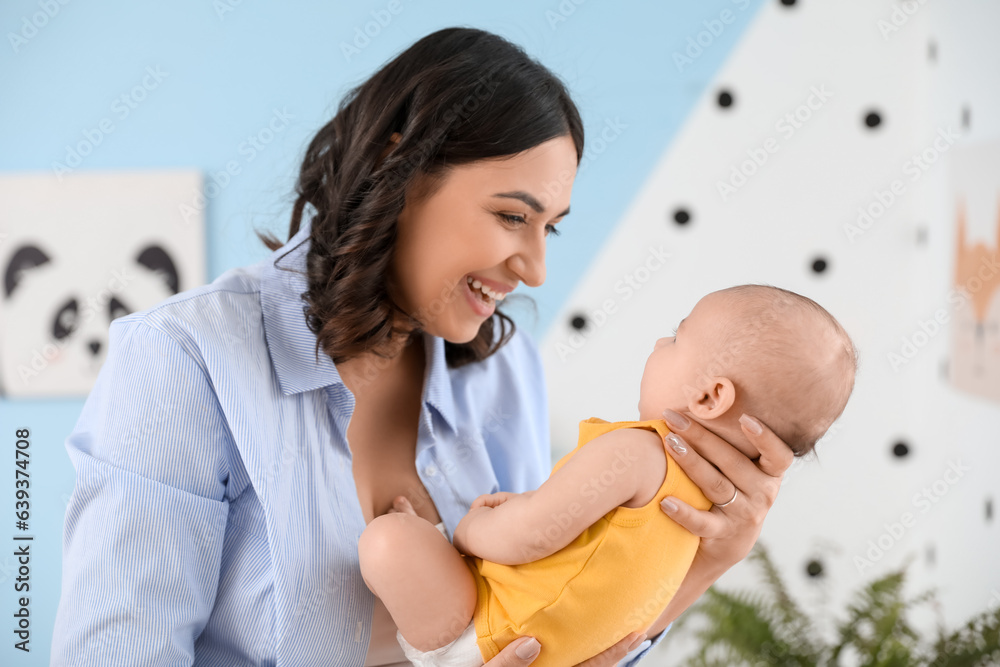 Young woman with her baby in bedroom