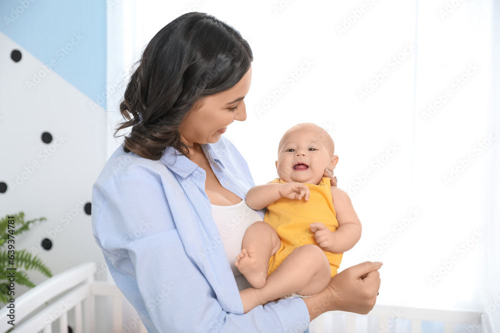 Young woman with her baby in bedroom