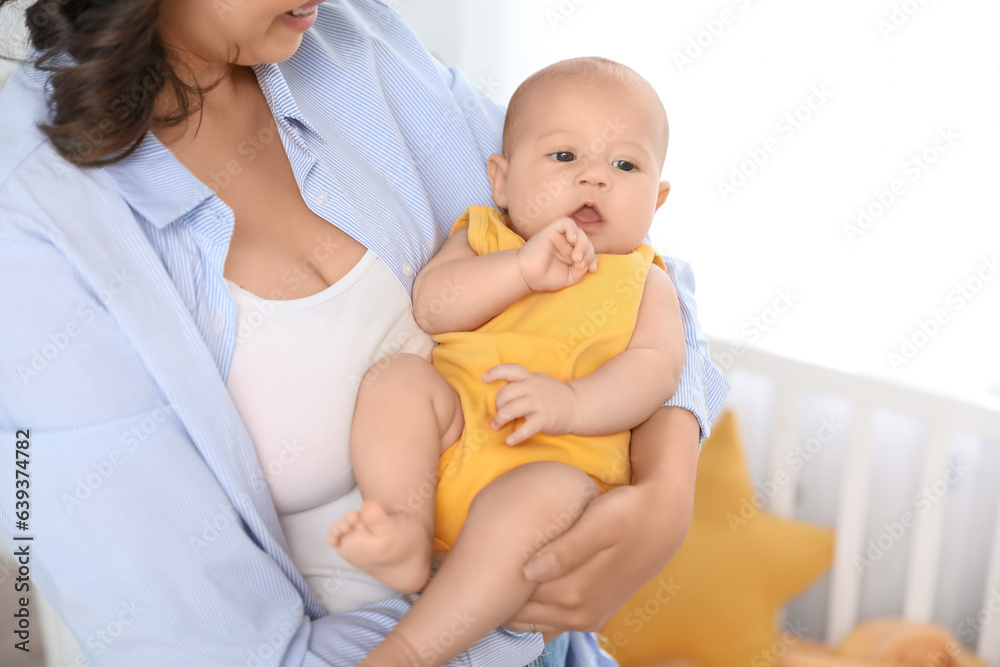 Young woman with her baby in bedroom, closeup