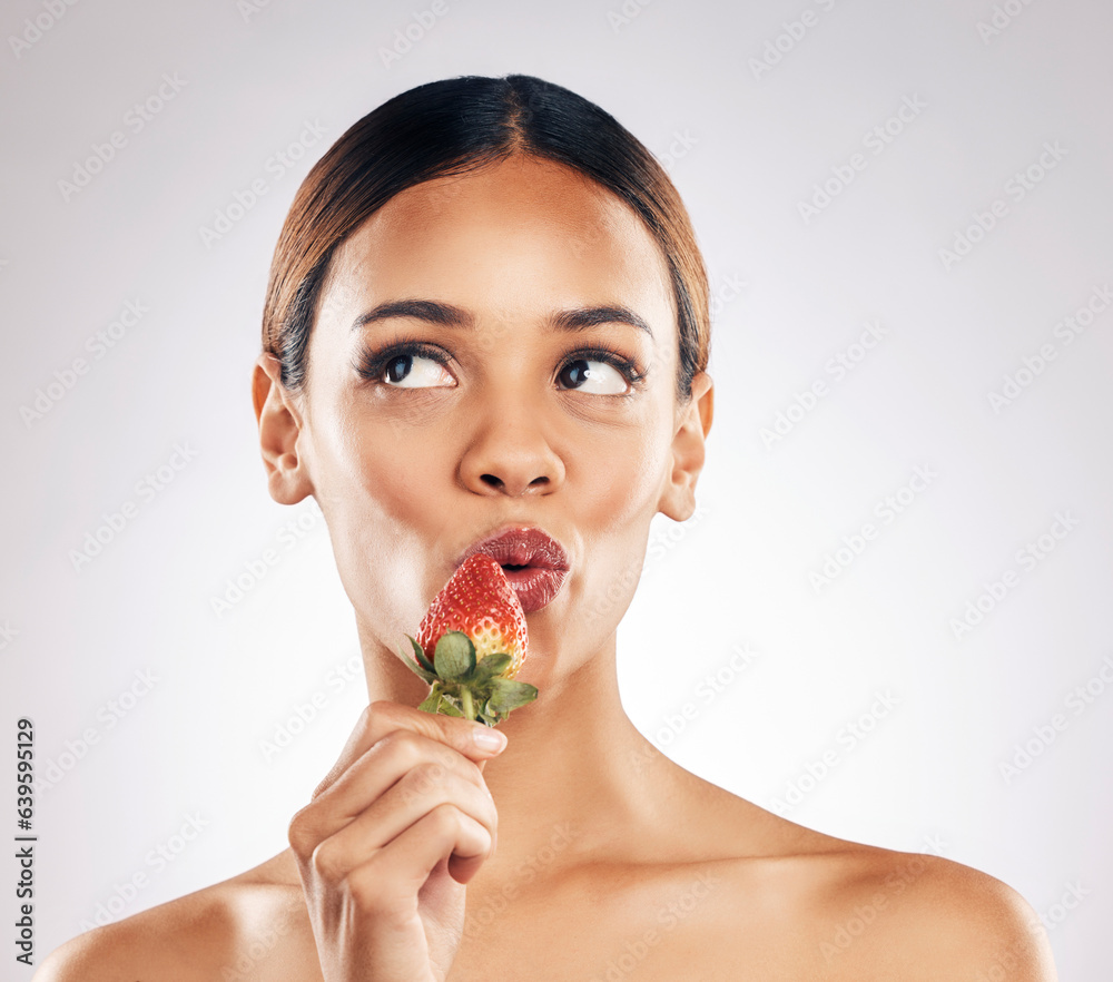 Skincare, kiss and woman with strawberry in studio for wellness, nutrition or natural cosmetics on w