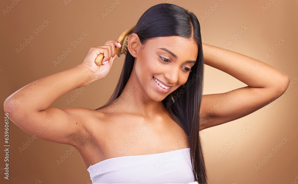 Beauty, smile and woman brushing hair in studio for growth, texture or shine against a brown backgro