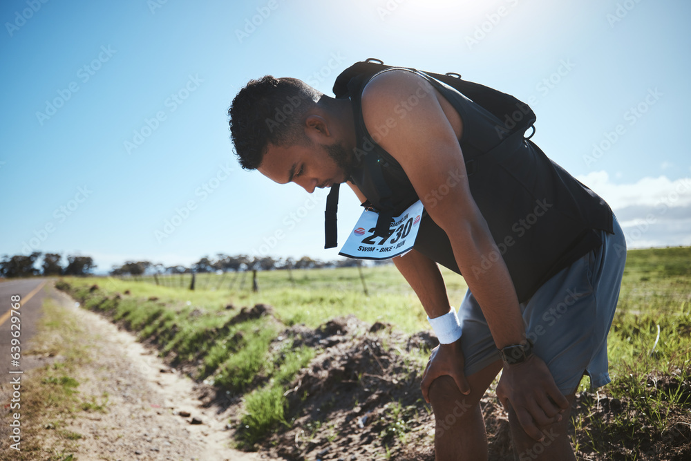 Fitness, breathing and tired man in road for training, workout or intense cardio outdoor performance