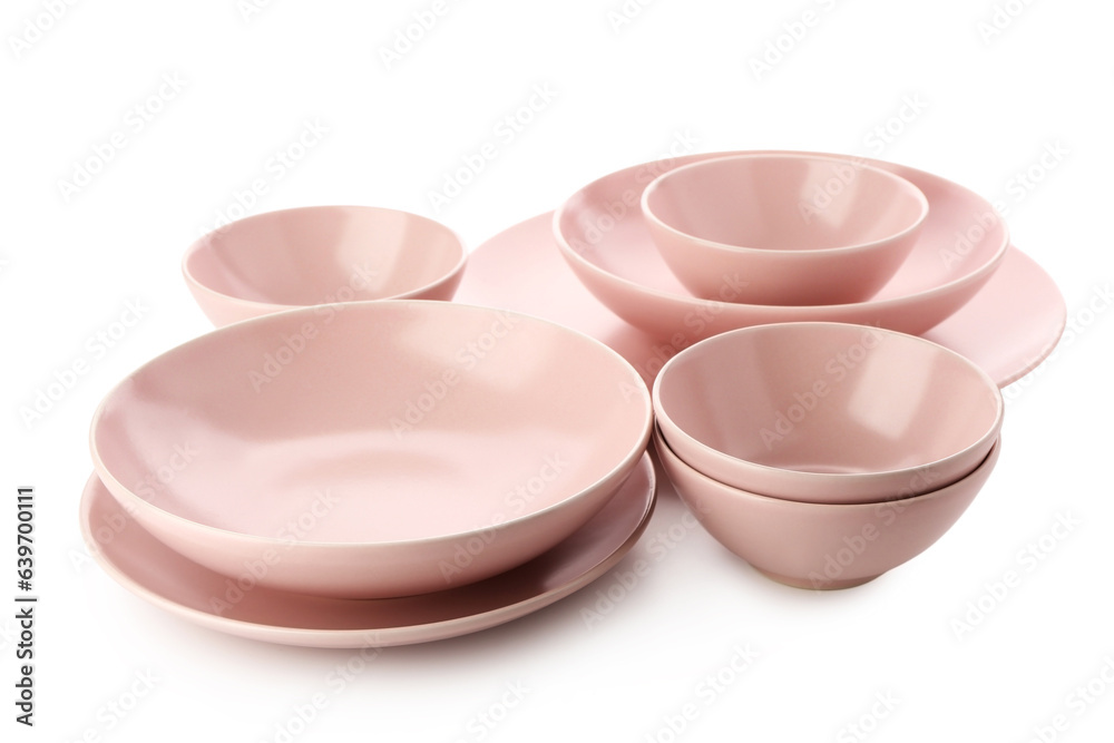 Set of different pink plates on white background