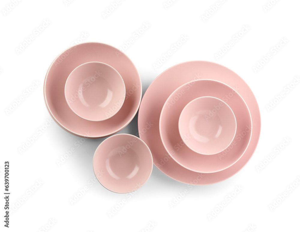 Set of different pink plates on white background