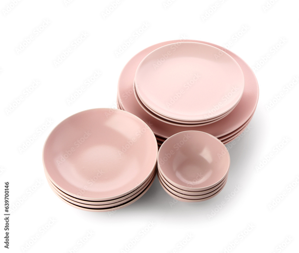 Set of different pink plates on white background