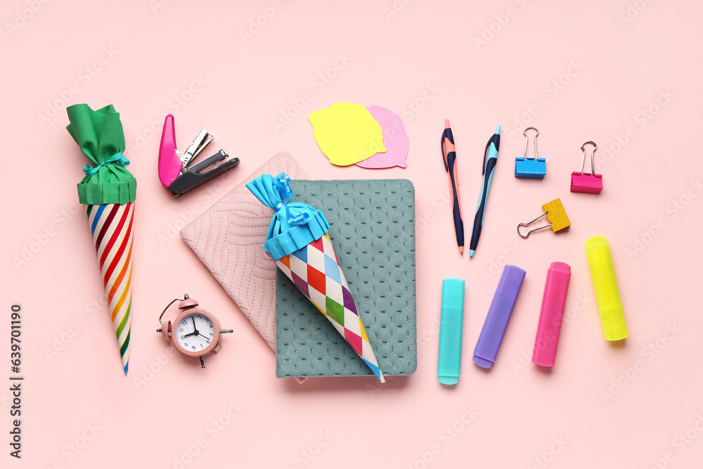 Colorful school cones and stationery on pink background