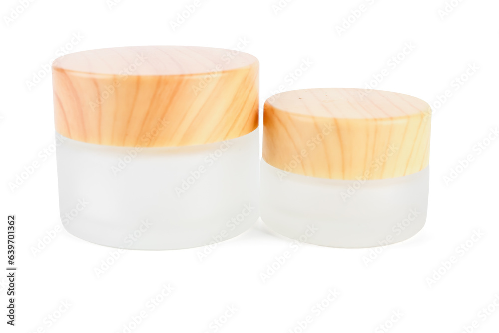 Cosmetic jars with wooden lids on white background