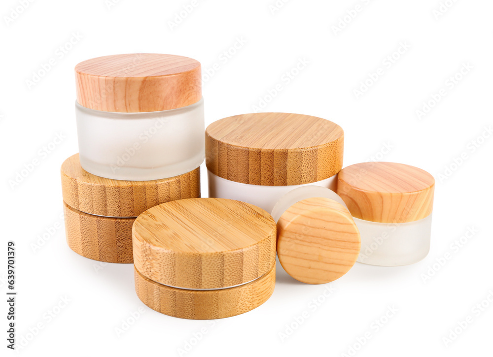 Set of different cosmetic jars on white background