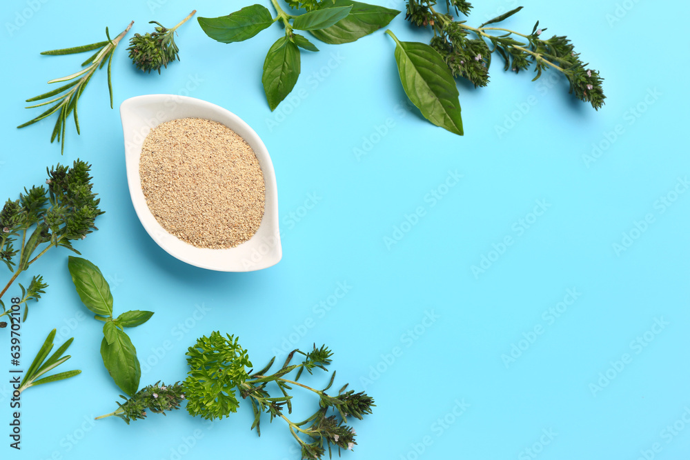 Composition with bowl of spices and fresh herbs on color background