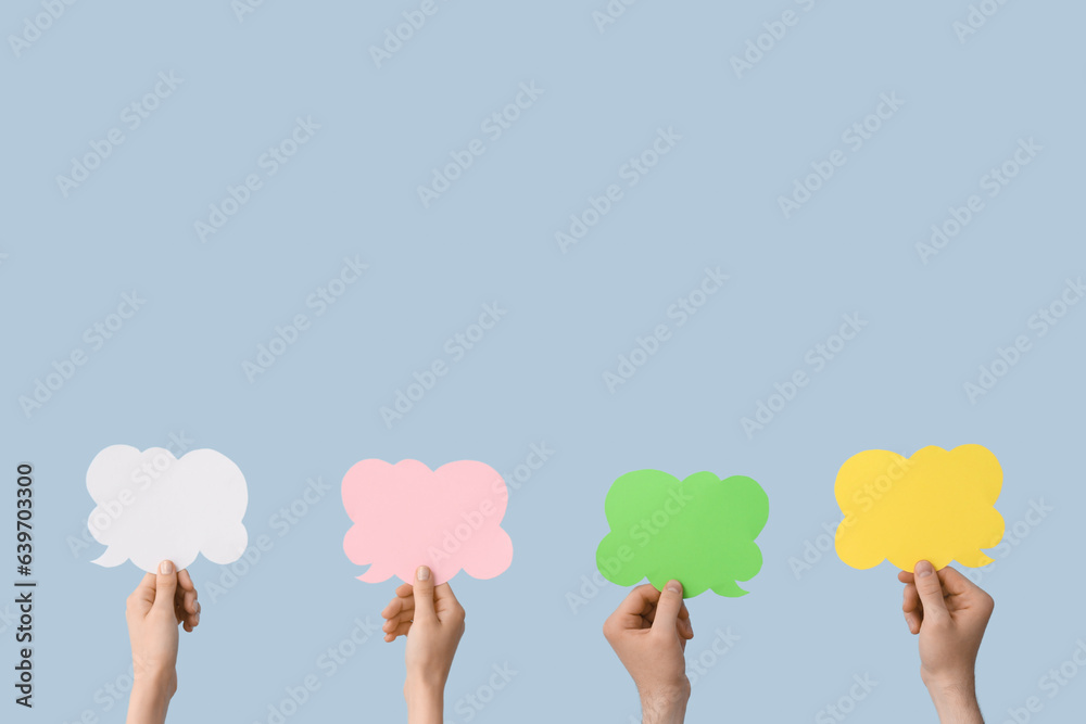 Female hands with speech bubbles on blue background