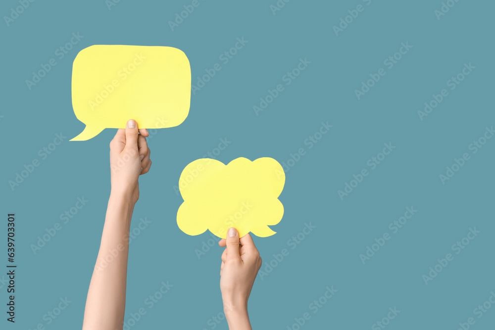 Female hands with speech bubbles on blue background