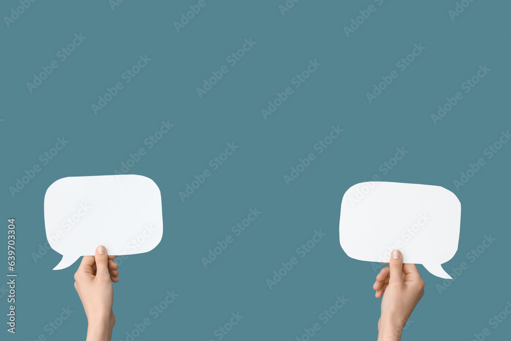 Female hands with speech bubbles on blue background