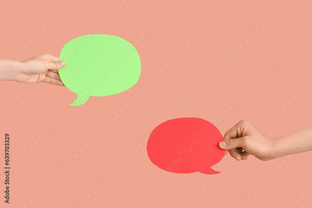 Different hands with speech bubbles on red background