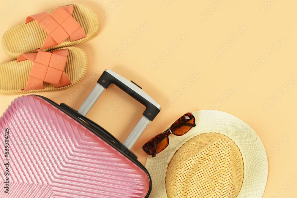 Stylish hat, shoes, sunglasses and suitcase on color background