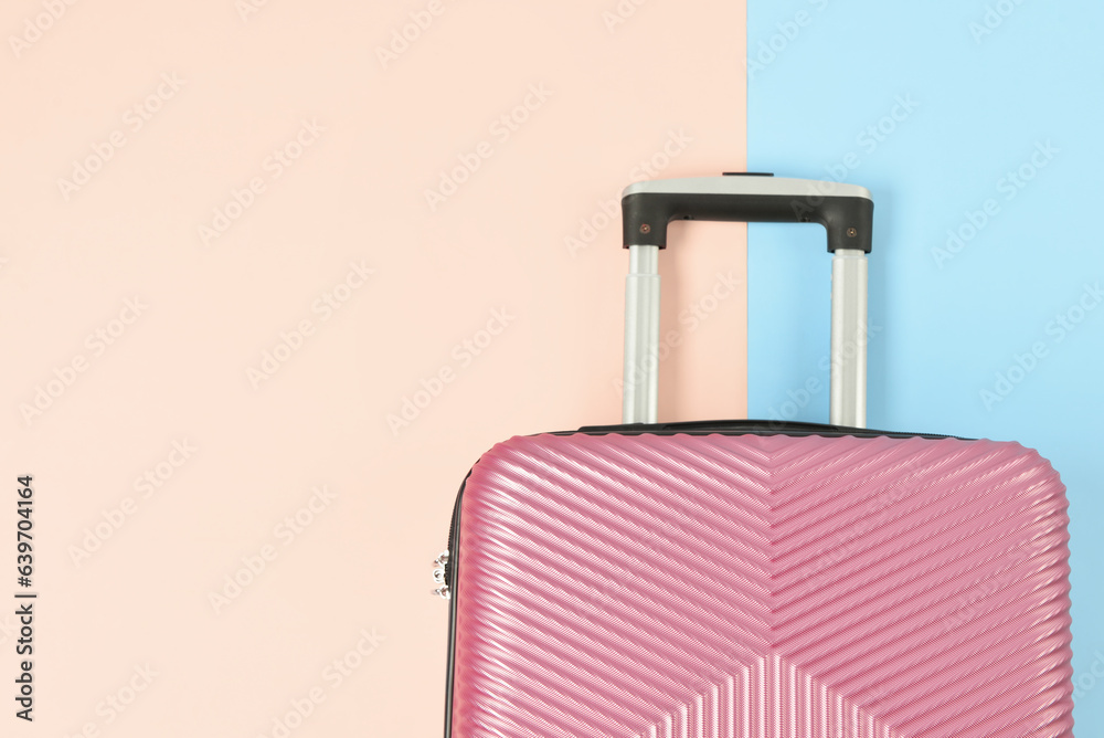 Stylish suitcase on color background, closeup