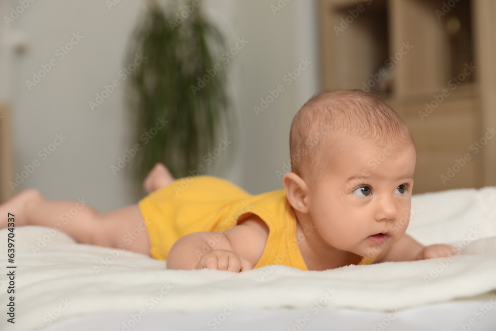 Cute baby lying on bed at home, closeup