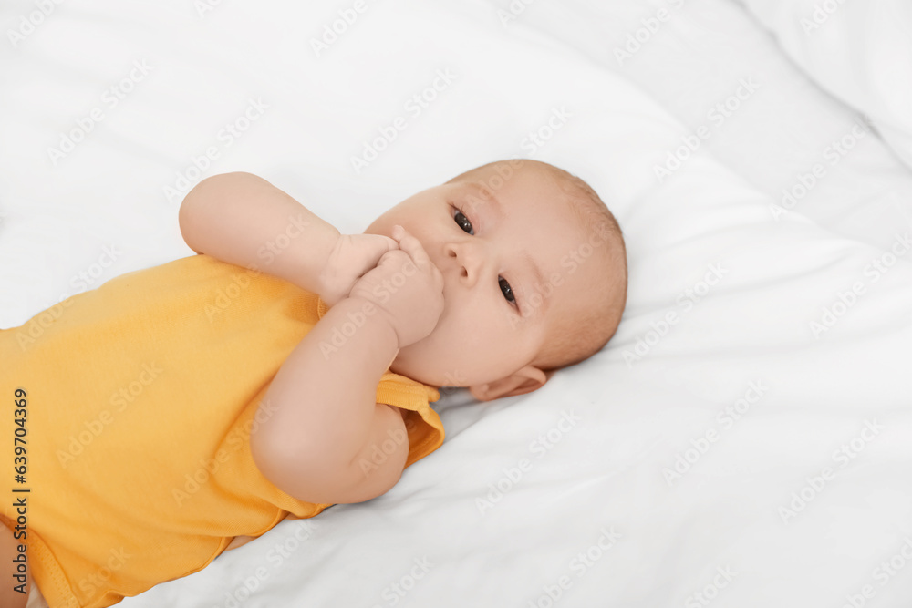 Cute baby lying on bed, closeup