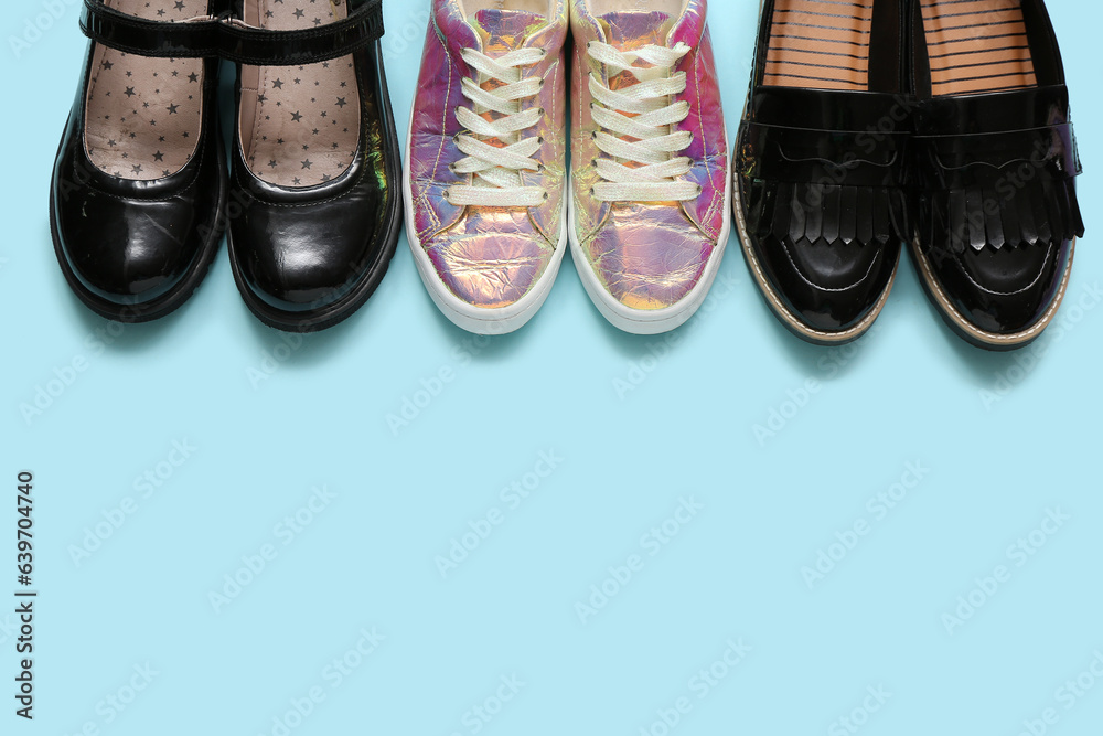 Set of different childs shoes on color background