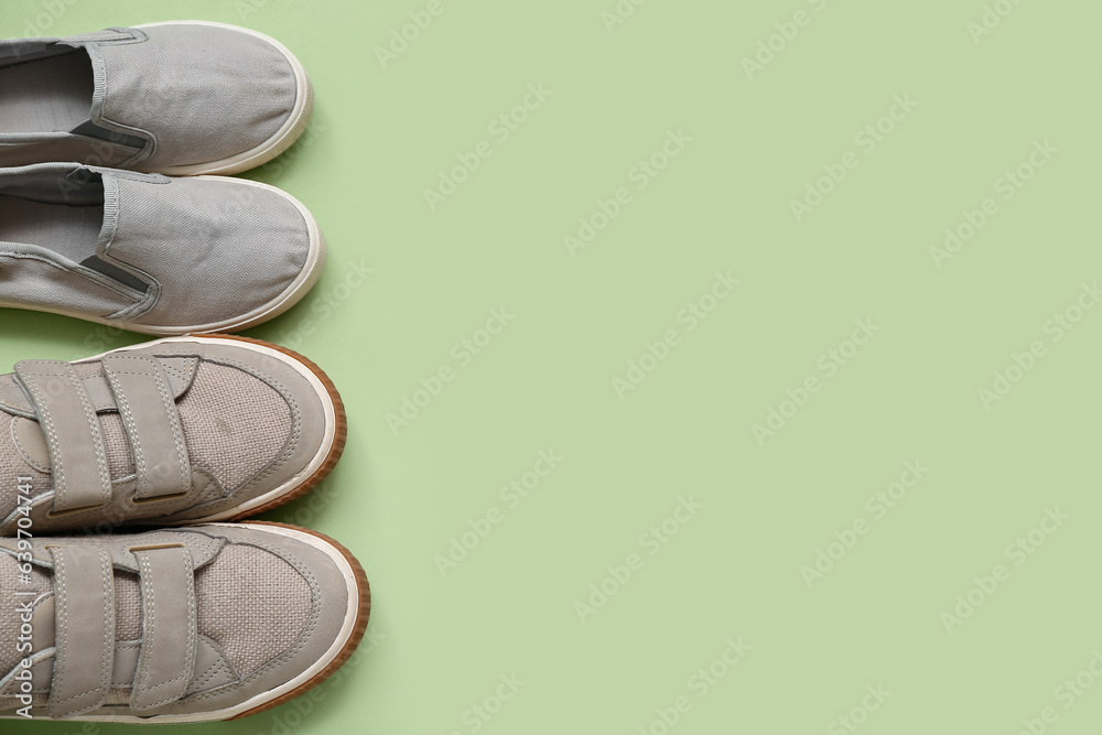 Stylish childs shoes on green background