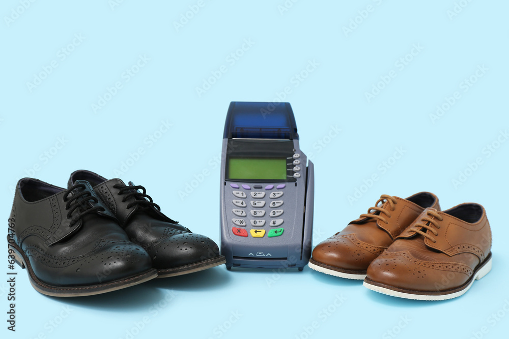 Payment terminal and stylish childs shoes on color background