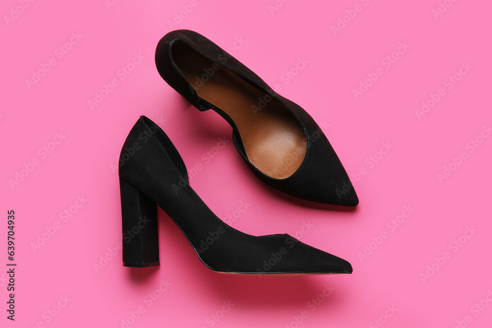 Stylish black high heels on pink background