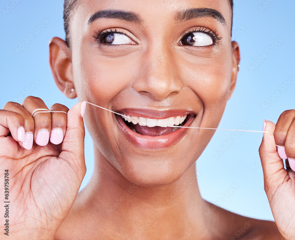 Woman, smile and floss teeth in studio for healthy dental care, gum gingivitis or plaque on blue bac