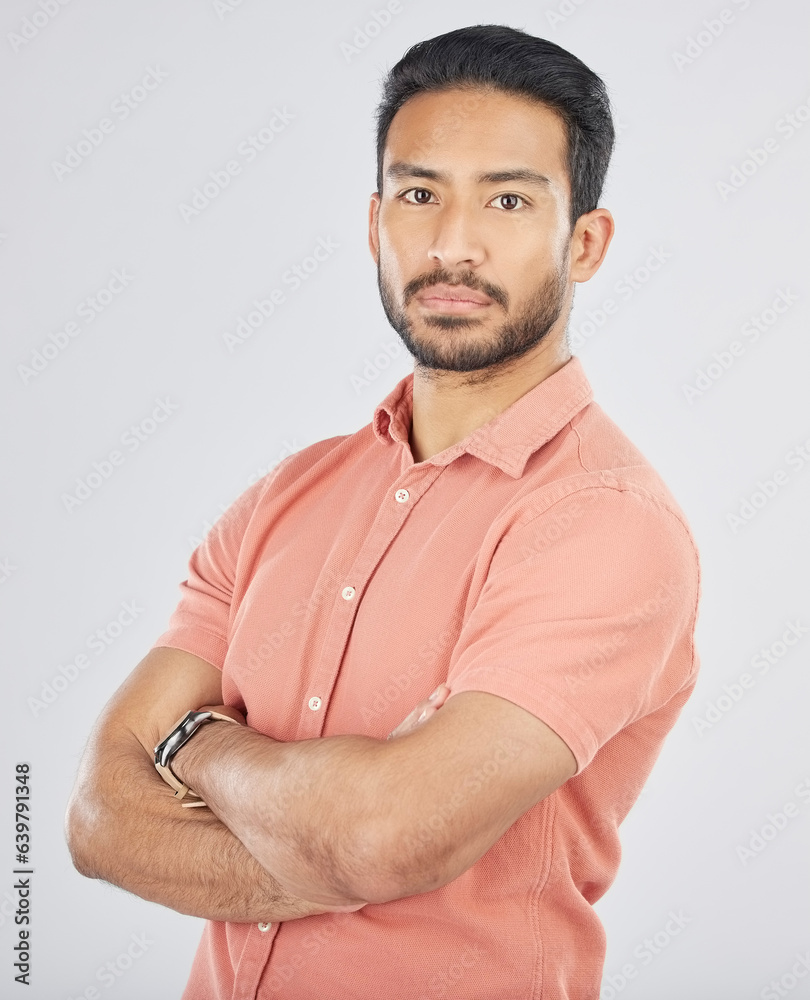 Portrait, confident and arms crossed with a serious asian man in studio on gray background. Fashion,