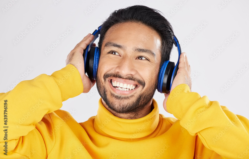 Model man, headphones and smile in studio, thinking and ideas with streaming subscription by white b