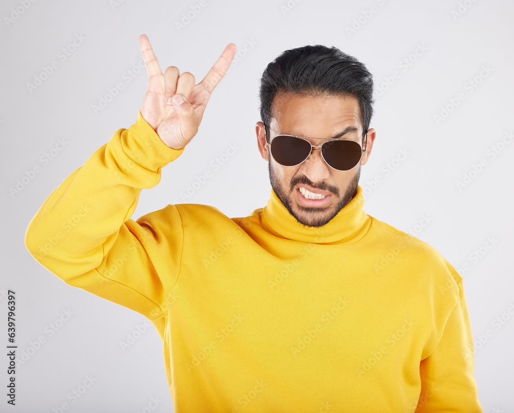 Man, sunglasses and horns sign in studio portrait, rock icon or hand gesture with clothes by white b