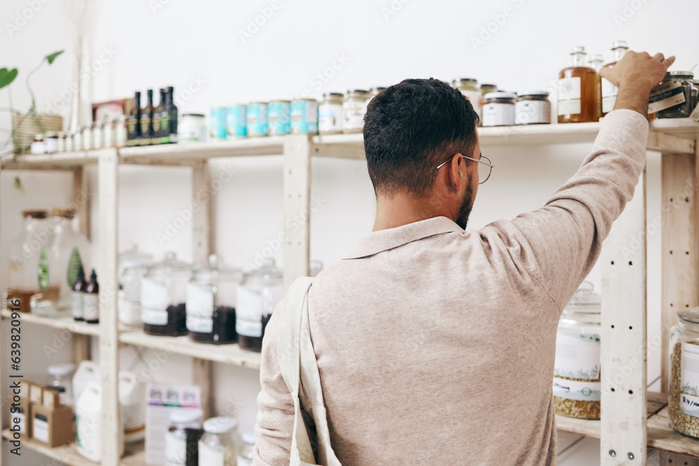 Customer, back and shopping by shelf in grocery store for healthy food, nutrition and wellness produ