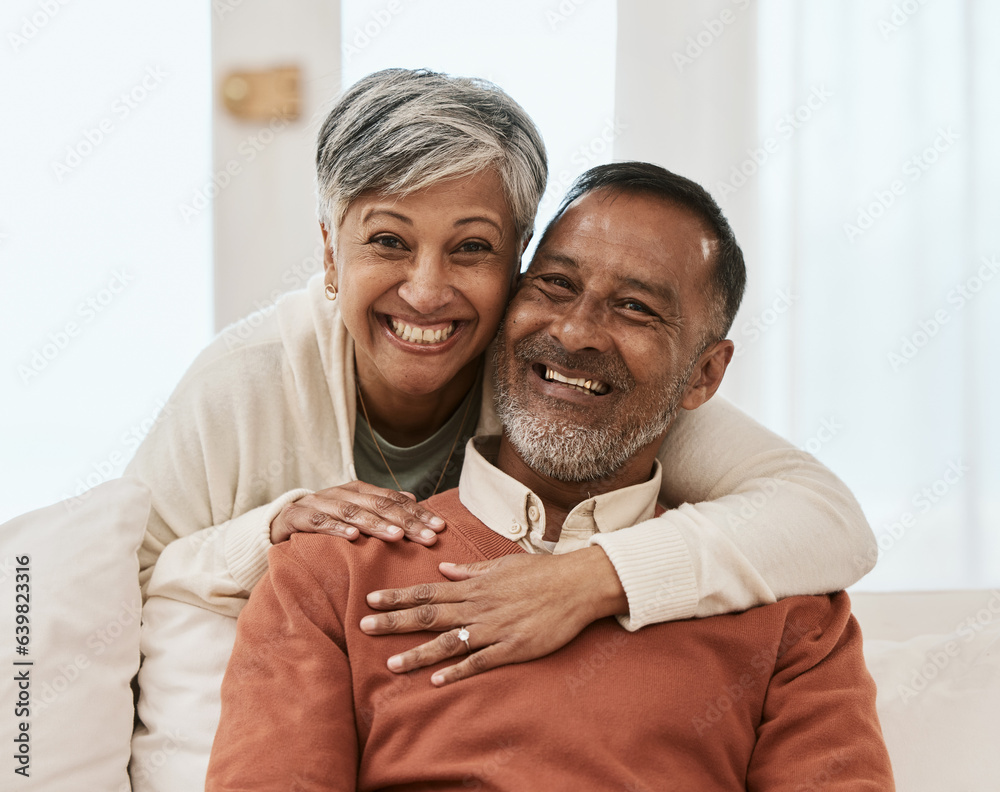 Smile, portrait and senior couple hug on sofa in living room relax, laugh and bond in their home. Fa