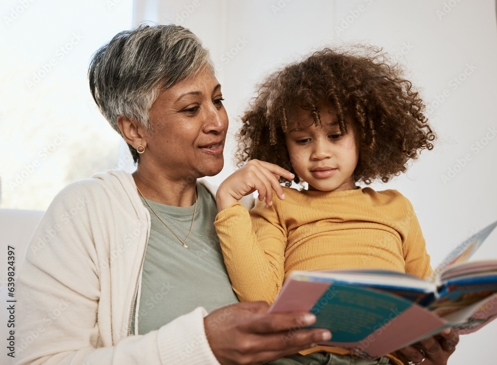 Home, grandmother and young child reading book, cartoon comic and bonding with senior woman in loung