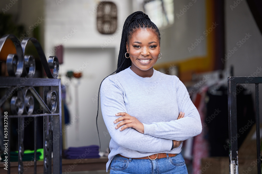 Happy black woman, portrait and arms crossed in clothes store, thrift shop or fashion workshop in ow