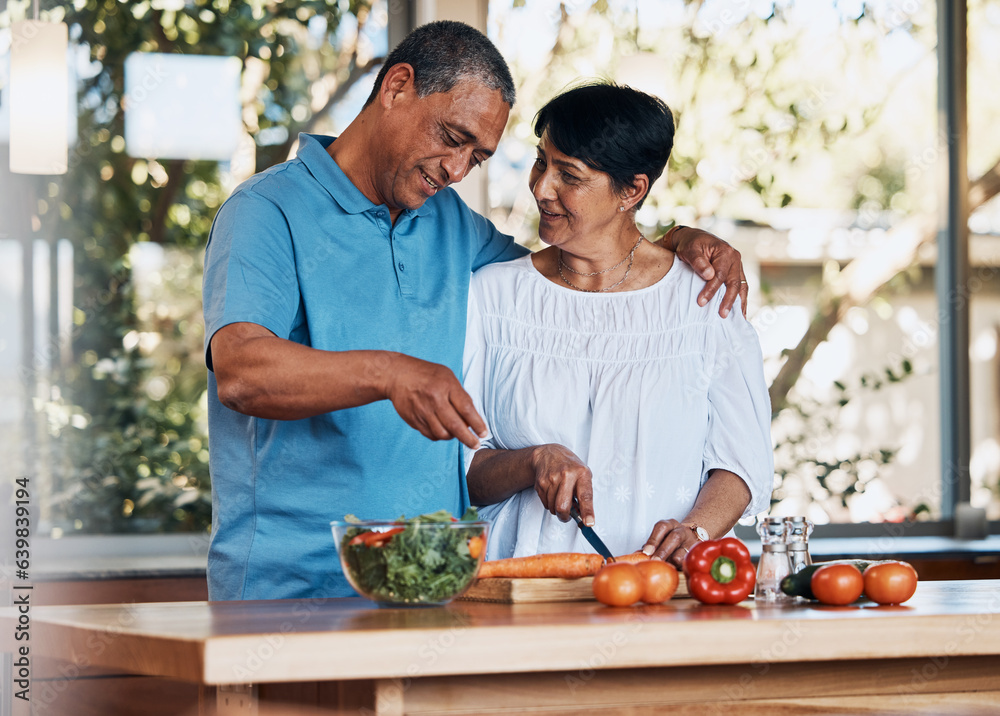 Happy couple, love and hug while cooking food, cutting carrot and prepare vegetables for salad at ho