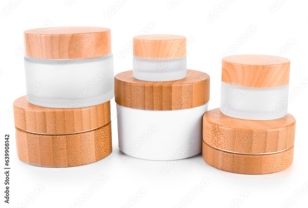 Set of different cosmetic jars on white background