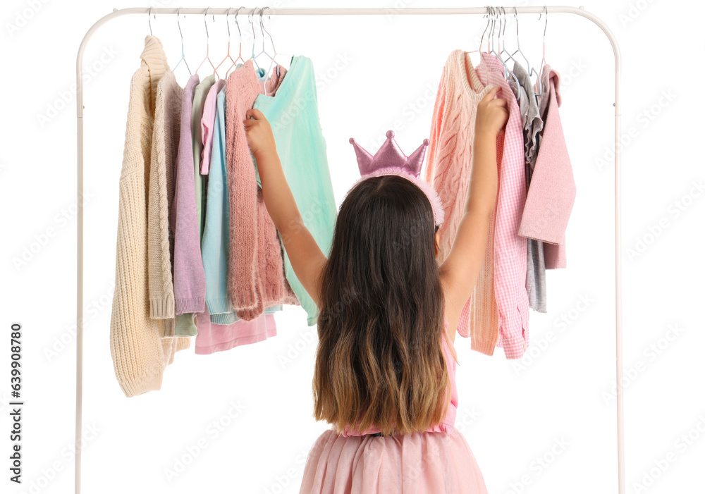 Cute little girl near rack with stylish clothes on white background, back view