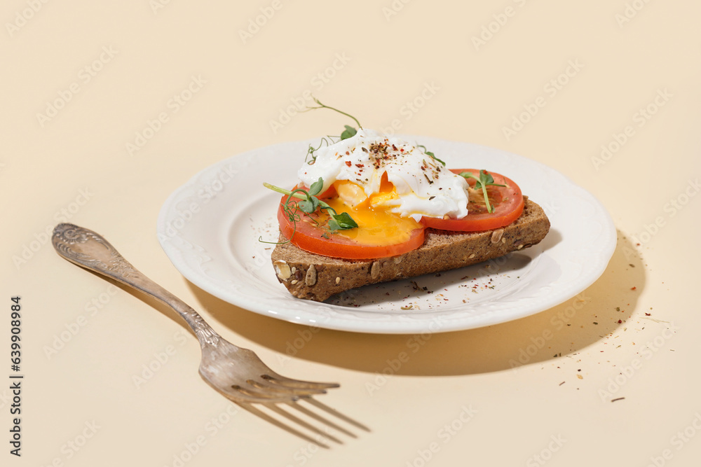 Plate of tasty sandwich with egg on yellow background