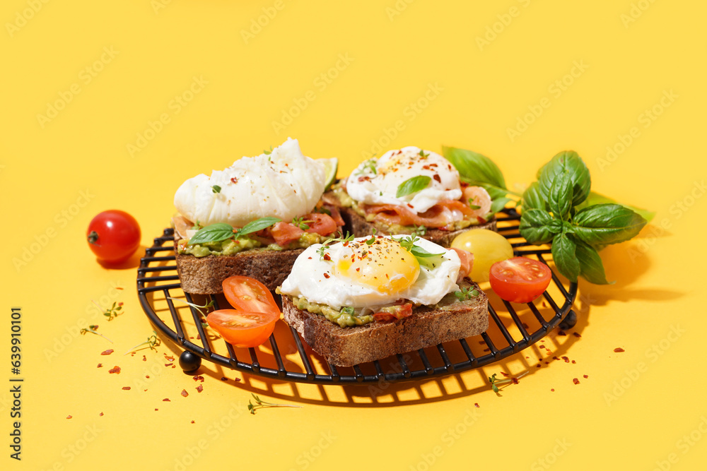 Grid of tasty sandwiches with egg on yellow background