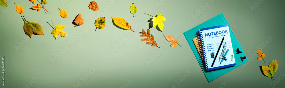 Notebooks with school supplies and autumn leaves - flat lay