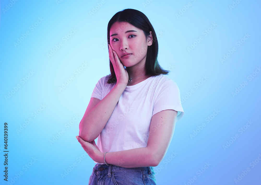 Fashion, neon and portrait of Asian woman in studio for style, promotion and retail sale on blue bac