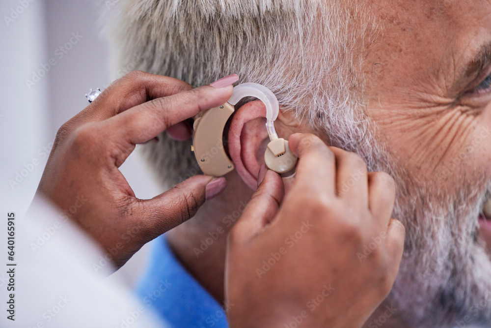 Healthcare, hands and doctor with hearing aid for man for communication support. Closeup, medical an