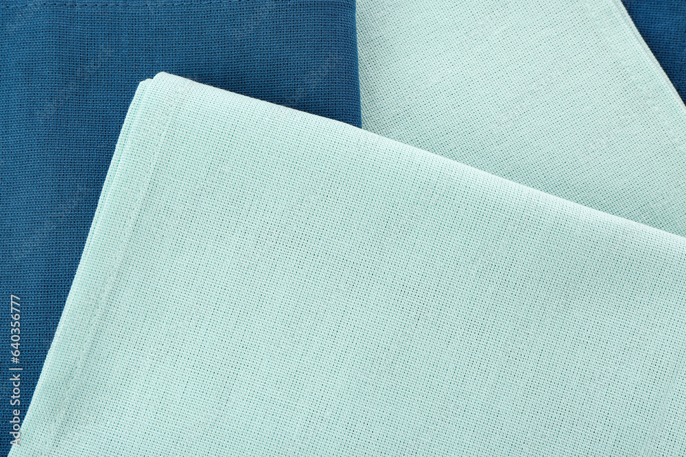 Folded clean napkins as background, closeup