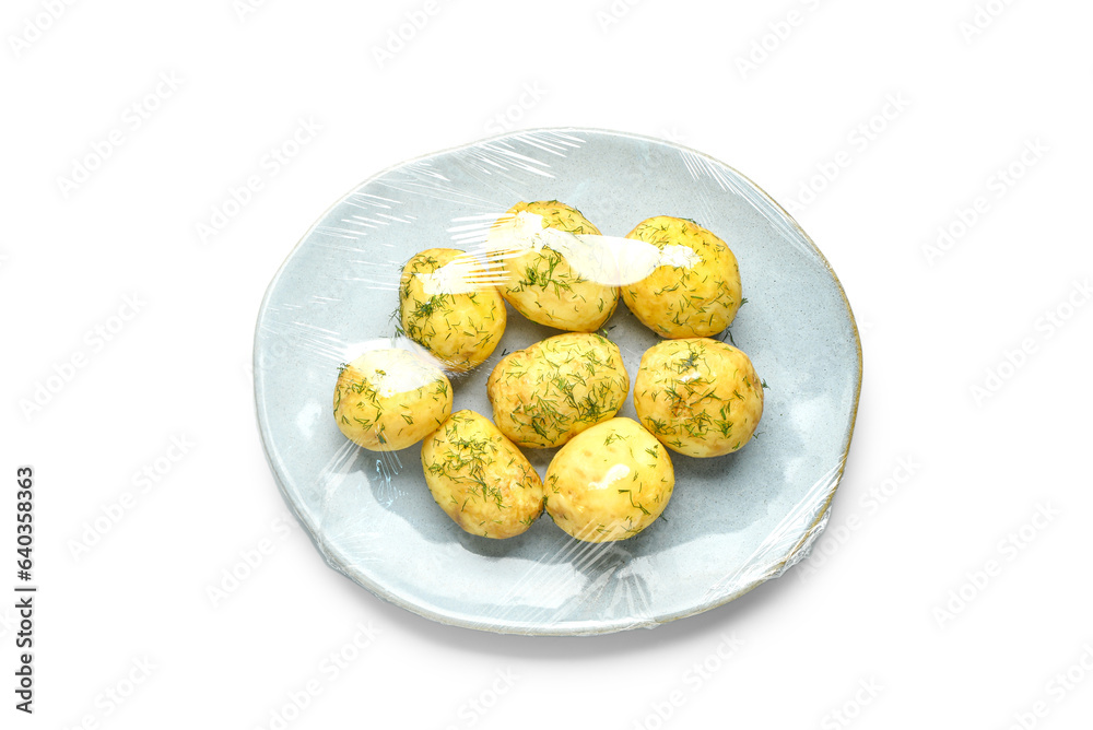 Plate of tasty boiled potatoes wrapped with stretch wrap on white background